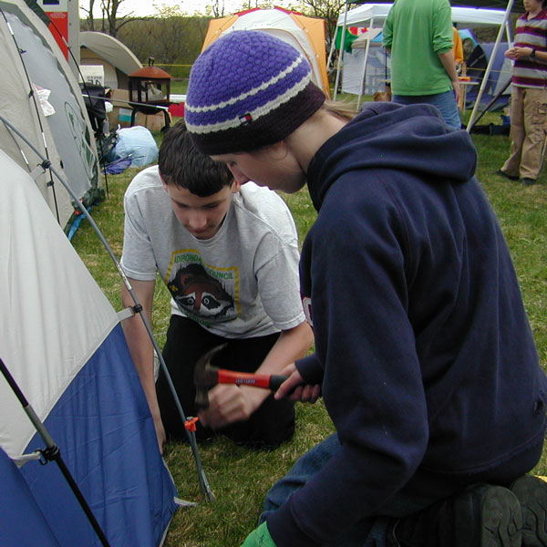 Hammering tent peg photo